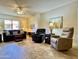 Spacious living room with neutral paint, wood flooring, and comfortable seating arrangement at 10330 W Thunderbird Blvd # C206, Sun City, AZ 85351