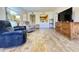 Bright living room featuring cozy seating, wood-look floors, and an open view to the kitchen at 10330 W Thunderbird Blvd # C206, Sun City, AZ 85351