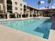 Inviting community pool area with lounge chairs, tables, and umbrellas, perfect for relaxation and recreation at 10330 W Thunderbird Blvd # C206, Sun City, AZ 85351