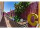 Backyard featuring colorful planters with a rock garden, cacti and a decorated block wall at 10449 E Jacob Ave, Mesa, AZ 85209