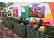 Whimsical backyard featuring garden beds with art, plantings, and a painted block wall at 10449 E Jacob Ave, Mesa, AZ 85209