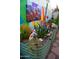 Backyard featuring garden beds with colorful landscaping, koi statues and a painted block wall at 10449 E Jacob Ave, Mesa, AZ 85209