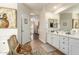 Bathroom featuring double sinks, chair, and access to the bedroom, making it a functional and stylish space at 10449 E Jacob Ave, Mesa, AZ 85209