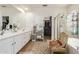 Bathroom with double sinks, a vanity, shower, and separate tub, offering a spa-like experience at 10449 E Jacob Ave, Mesa, AZ 85209