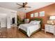 Bedroom with wood floors, green bed, and colorful desert wall mural offers a unique, personalized space at 10449 E Jacob Ave, Mesa, AZ 85209