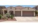 Inviting single-story home featuring desert landscaping and a convenient two-car garage at 10449 E Jacob Ave, Mesa, AZ 85209