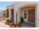 Charming front porch area adorned with potted plants, decorative features, and a secure entrance at 10449 E Jacob Ave, Mesa, AZ 85209