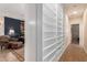 Hallway with custom built in shelves leads into a sitting room, enhancing the home's unique charm at 10449 E Jacob Ave, Mesa, AZ 85209