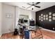 A modern home office with sleek desk, comfortable chair, natural light, and wood-style flooring at 10449 E Jacob Ave, Mesa, AZ 85209