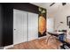 This versatile home office features a large closet, natural light, and wood-style flooring for a comfortable workspace at 10449 E Jacob Ave, Mesa, AZ 85209