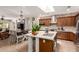 Open concept kitchen with a center island, wood cabinets, and seamless flow to the adjacent living spaces at 10449 E Jacob Ave, Mesa, AZ 85209