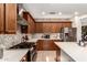 Modern kitchen with stainless steel appliances, quartz countertops, and dark wood cabinetry at 10449 E Jacob Ave, Mesa, AZ 85209