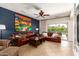 Comfortable living room with leather sectional sofa, ceiling fan, and access to outdoor pool area at 10449 E Jacob Ave, Mesa, AZ 85209