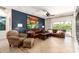 Inviting living room with a large leather sectional, stylish accents, and sliding doors to the pool at 10449 E Jacob Ave, Mesa, AZ 85209