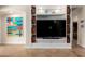 Living room featuring a custom built-in shelving unit with decorative baskets and modern decor at 10449 E Jacob Ave, Mesa, AZ 85209