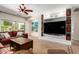 Living area featuring a built-in shelving unit and large sliding glass doors to the backyard at 10449 E Jacob Ave, Mesa, AZ 85209