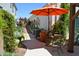 Cozy outdoor dining and relaxing area with a bright orange umbrella at 10449 E Jacob Ave, Mesa, AZ 85209