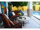 Outdoor seating area with a comfortable sofa and chairs by the pool at 10449 E Jacob Ave, Mesa, AZ 85209