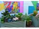 Eclectic backyard garden featuring art, fish ornaments and colorful plantings in metal troughs at 10449 E Jacob Ave, Mesa, AZ 85209