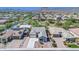 An aerial view of the houses and the neighborhood with mountain views, desert landscaping and tiled roofs at 10664 E Ellis St, Mesa, AZ 85207