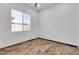 Bright bedroom with tiled floors, neutral walls, a ceiling fan, and a window at 10664 E Ellis St, Mesa, AZ 85207