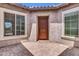 Private courtyard featuring a neutral stucco finish, brick pavers, and large windows for natural light at 10664 E Ellis St, Mesa, AZ 85207