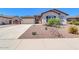 Charming single-story home featuring desert landscaping, a two-car garage, and a neutral color palette at 10664 E Ellis St, Mesa, AZ 85207