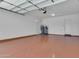 A clean garage with finished floors, clean white walls and a utility closet at 10664 E Ellis St, Mesa, AZ 85207