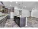 Spacious kitchen features dark cabinets, granite countertops, large island and gray subway tile backsplash at 10664 E Ellis St, Mesa, AZ 85207