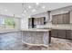 Kitchen features dark cabinetry, granite countertops, stainless appliances, and a gray mosaic-tiled island at 10664 E Ellis St, Mesa, AZ 85207