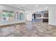 Spacious open-concept living area, featuring tile floors and modern kitchen at 10664 E Ellis St, Mesa, AZ 85207