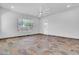 Bright living room with tile floors, recessed lighting, ceiling fan, and large window at 10664 E Ellis St, Mesa, AZ 85207