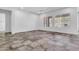 Spacious living room featuring tile floors, recessed lighting, a ceiling fan, and bright windows at 10664 E Ellis St, Mesa, AZ 85207