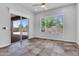 Bright living room with large windows, tiled flooring, and an open sliding glass door at 10664 E Ellis St, Mesa, AZ 85207