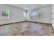 Bright living room showcasing tile floors, recessed lighting, and multiple windows at 10664 E Ellis St, Mesa, AZ 85207