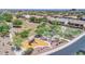 Aerial view of a neighborhood park, including a playground, walking paths, and lots of mature trees at 10664 E Ellis St, Mesa, AZ 85207