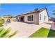 Paver patio with built-in grill, outdoor fireplace, and small patch of artificial turf at 10664 E Ellis St, Mesa, AZ 85207