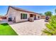 Large paver patio with a built-in grill, outdoor fireplace, and some artificial turf at 10664 E Ellis St, Mesa, AZ 85207
