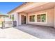 Large paver patio featuring a built-in grill station and covered section with multiple windows at 10664 E Ellis St, Mesa, AZ 85207
