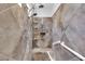 Tiled shower with multiple shower heads, built-in shelving, and a seating ledge at 10664 E Ellis St, Mesa, AZ 85207