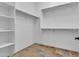 Walk-in closet featuring built-in shelving and hanging rods for optimal organization at 10664 E Ellis St, Mesa, AZ 85207