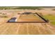 Wide angle aerial view of modern farmhouse with large fenced lot with desert backdrop at 11564 E Windsor Way, Florence, AZ 85132