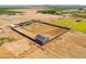 Spacious lot aerial view featuring fenced yard, barn, desert landscape and mountains in distance at 11564 E Windsor Way, Florence, AZ 85132
