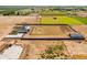 Expansive aerial view of property featuring modern farmhouse, barn, and foundations against rural fields at 11564 E Windsor Way, Florence, AZ 85132