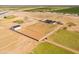 Sprawling aerial view of property showing modern home, barn, fields, and a building foundation under construction at 11564 E Windsor Way, Florence, AZ 85132