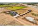 Wide aerial view showing modern farmhouse, barn, foundation work, and agricultural fields surrounding property at 11564 E Windsor Way, Florence, AZ 85132