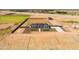 Aerial view of a home with long driveway, outbuilding, new landscaping and large lot at 11564 E Windsor Way, Florence, AZ 85132
