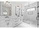 Stylish bathroom with double vanities, modern mirrors, and a luxurious glass-enclosed shower at 11564 E Windsor Way, Florence, AZ 85132