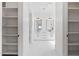 Elegant bathroom entry featuring open shelving and a view of the dual vanity area at 11564 E Windsor Way, Florence, AZ 85132