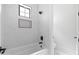 Elegant bathroom displays marble tile, a sleek bathtub, and modern black fixtures at 11564 E Windsor Way, Florence, AZ 85132